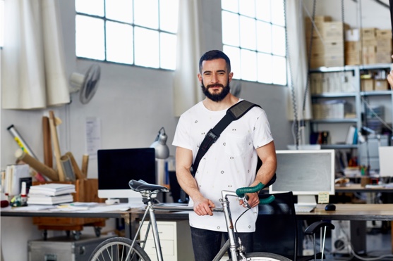 Man with his bike in his office